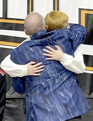 Coach Clint Bedore congratulates Carolina Northup on her fifth-place finish at state wrestling in Salina