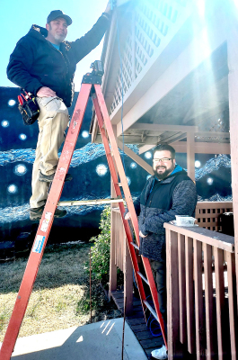 TECHNICIAN BENJAMIN ENGSTROM and programmer and technician Joshua Paul with Electronic Life of Topeka, installed the new sound system for Stockton’s Main Street last week.