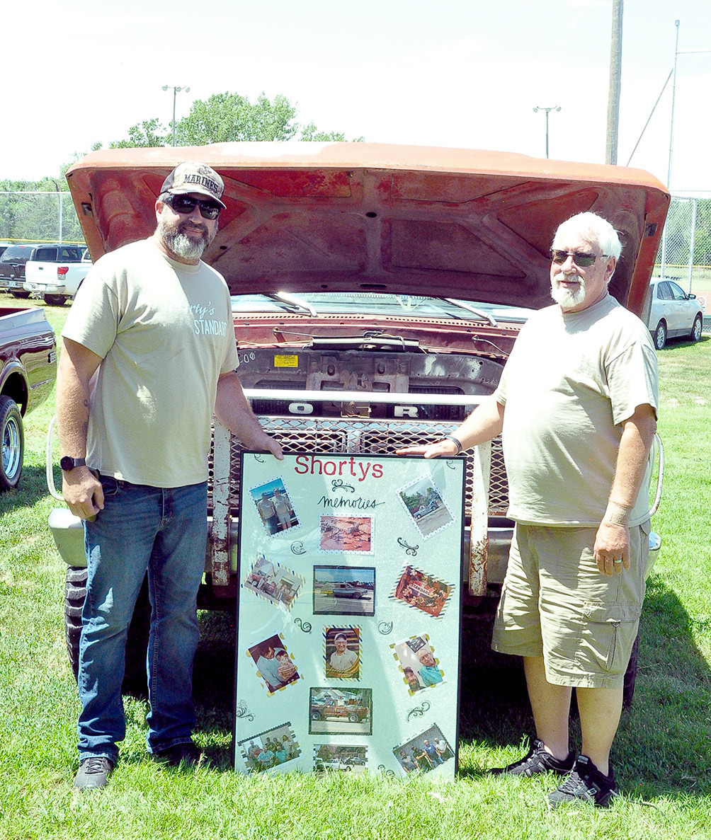 THE MEMORY OF SHORTY’S STANDARD and Shorty Emery, were on display, not only with a couple old vehicles, but with the memory board which contained pictures of his family and business ventures. Proudly visiting with folks about their grandfather and father were Seth Emery of Abilene (left), and Jeff Emery of Stockton.